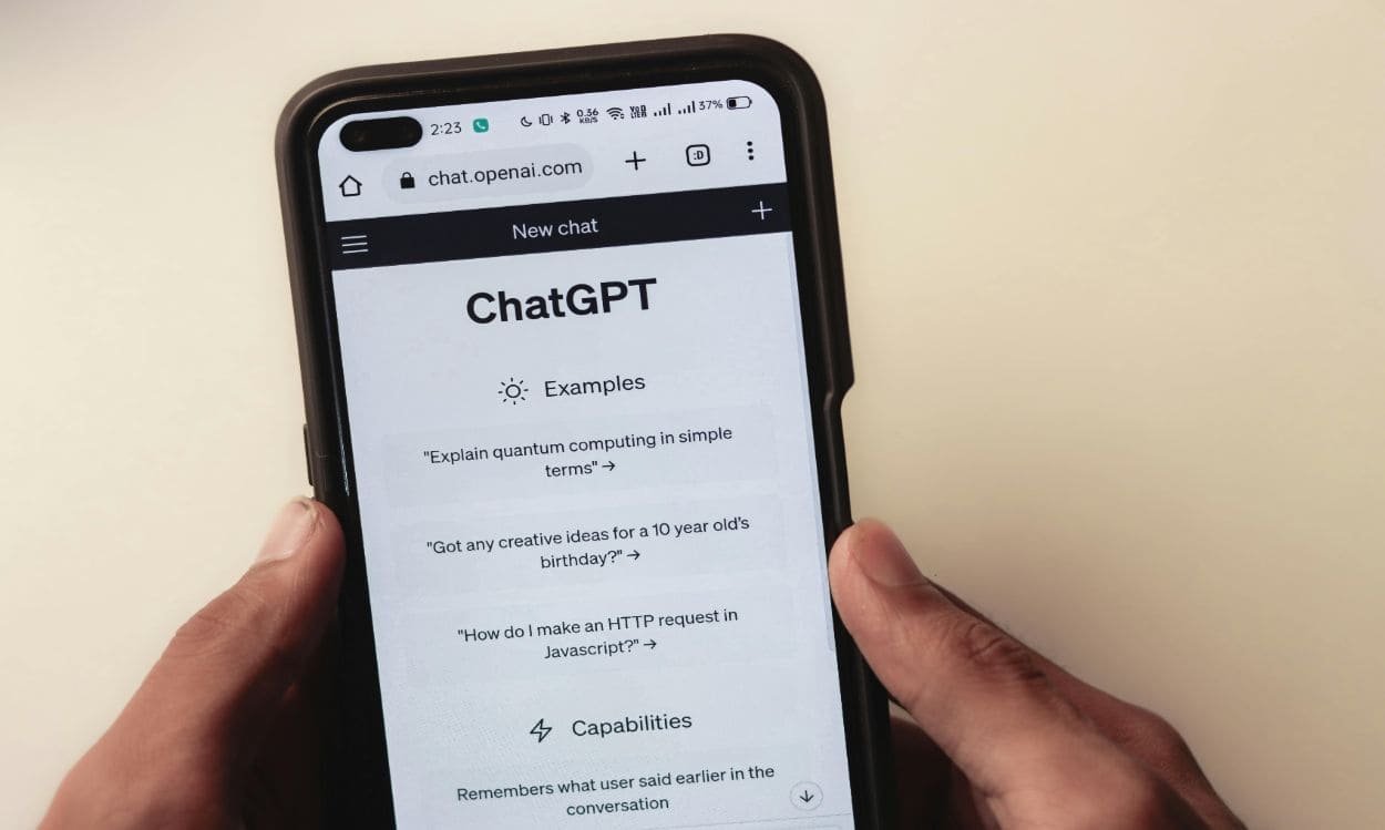 Student typing prompts into an AI assistant like ChatGPT on a Mobile Phone in 2025